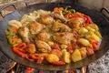 Chicken cooked on a plough disc